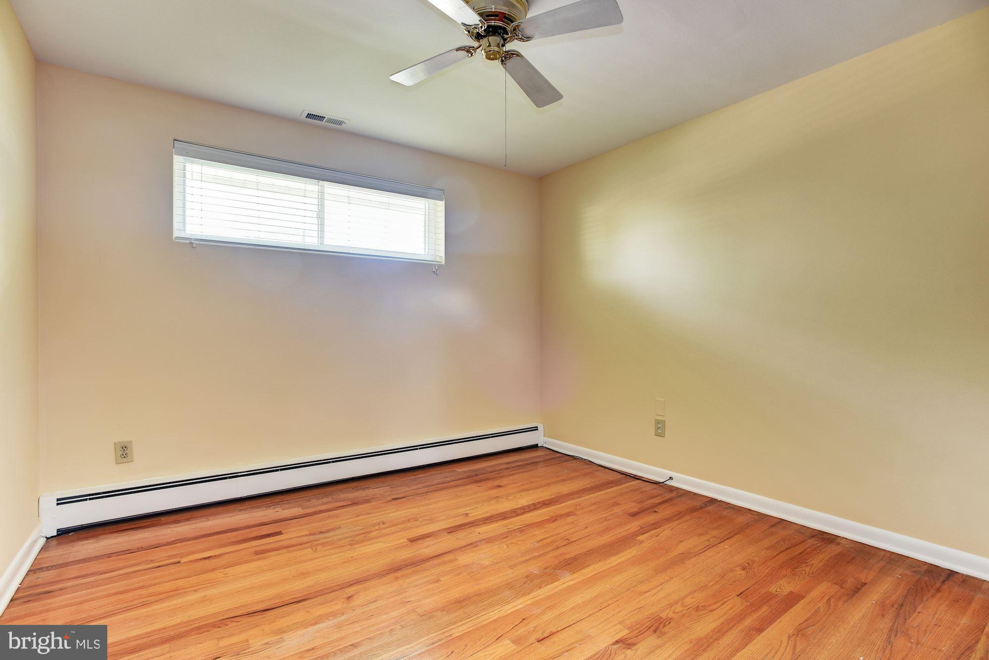 8492 Laurel Road Pasadena, MD 21122 - Photo 20 of 46 an empty room with a window and a ceiling fan