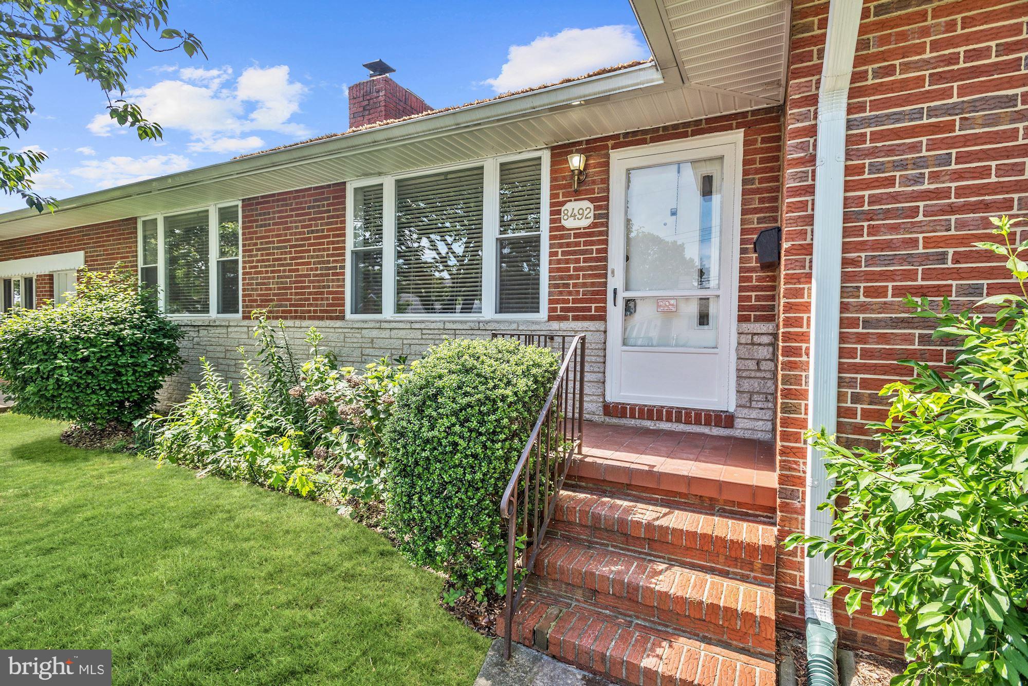 8492 Laurel Road Pasadena, MD 21122 - Photo 2 of 46 a front view of a house with a garden