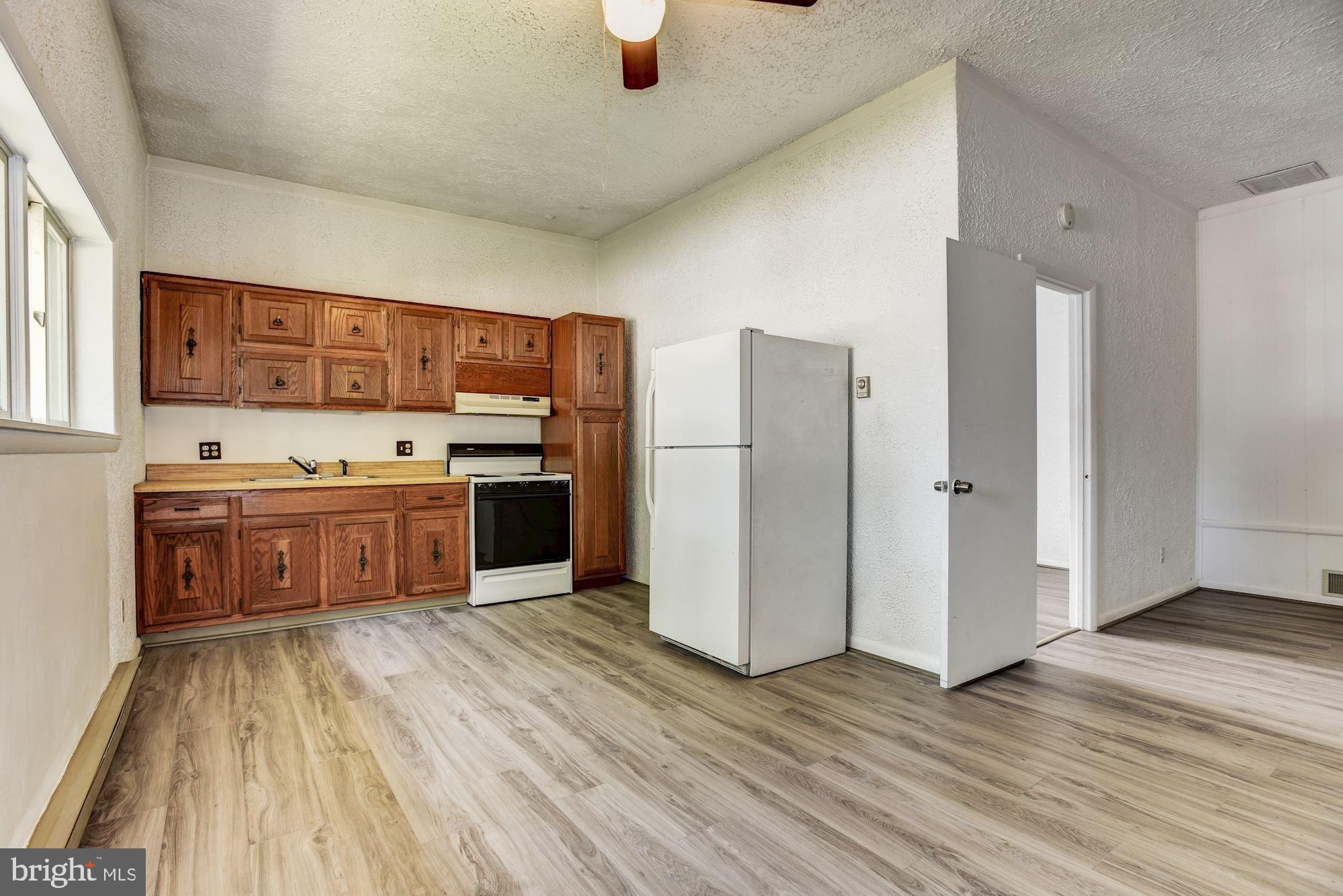 8492 Laurel Road Pasadena, MD 21122 - Photo 25 of 46 a kitchen with stainless steel appliances a refrigerator and a stove