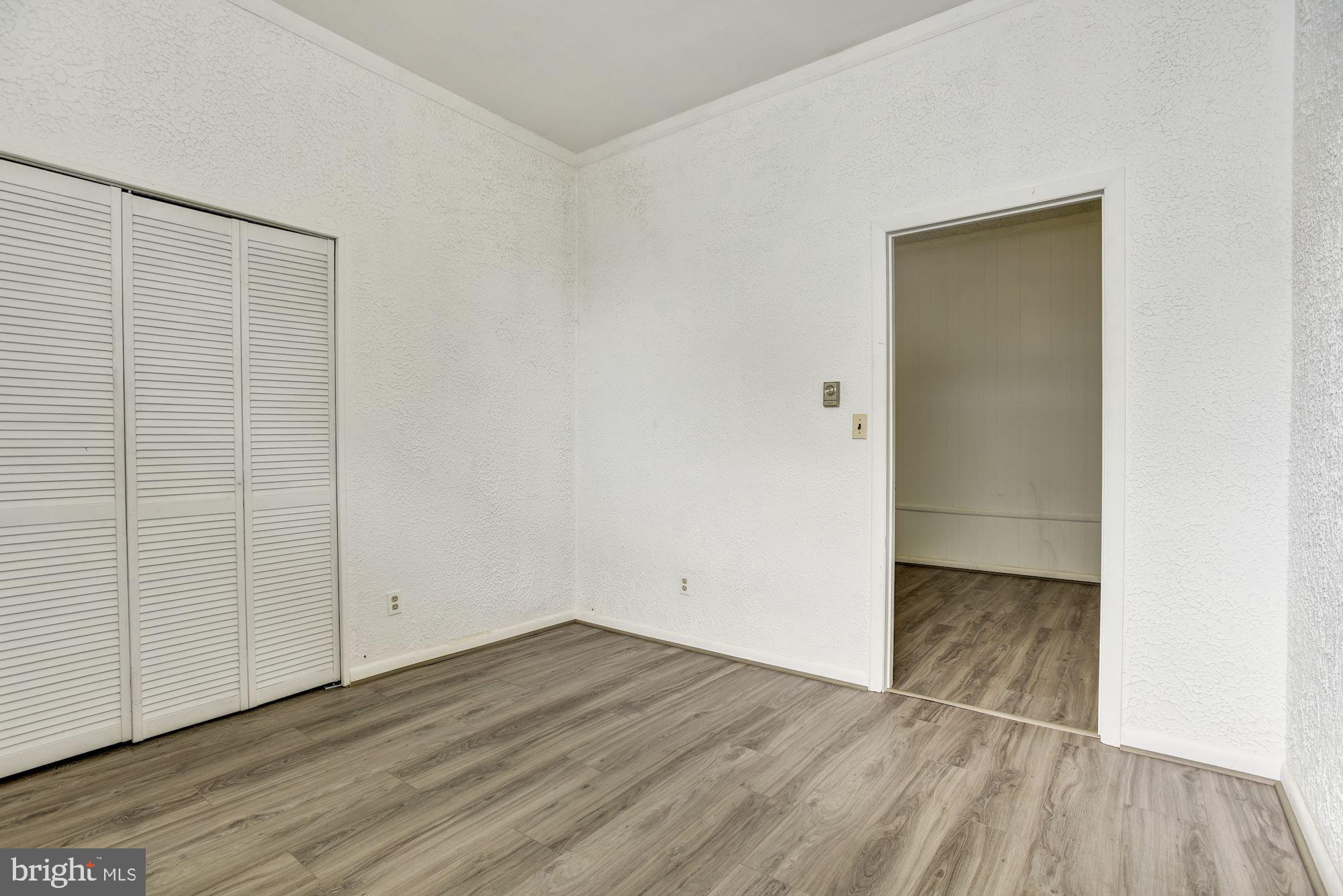 8492 Laurel Road Pasadena, MD 21122 - Photo 28 of 46 an empty room with wooden floor and closet