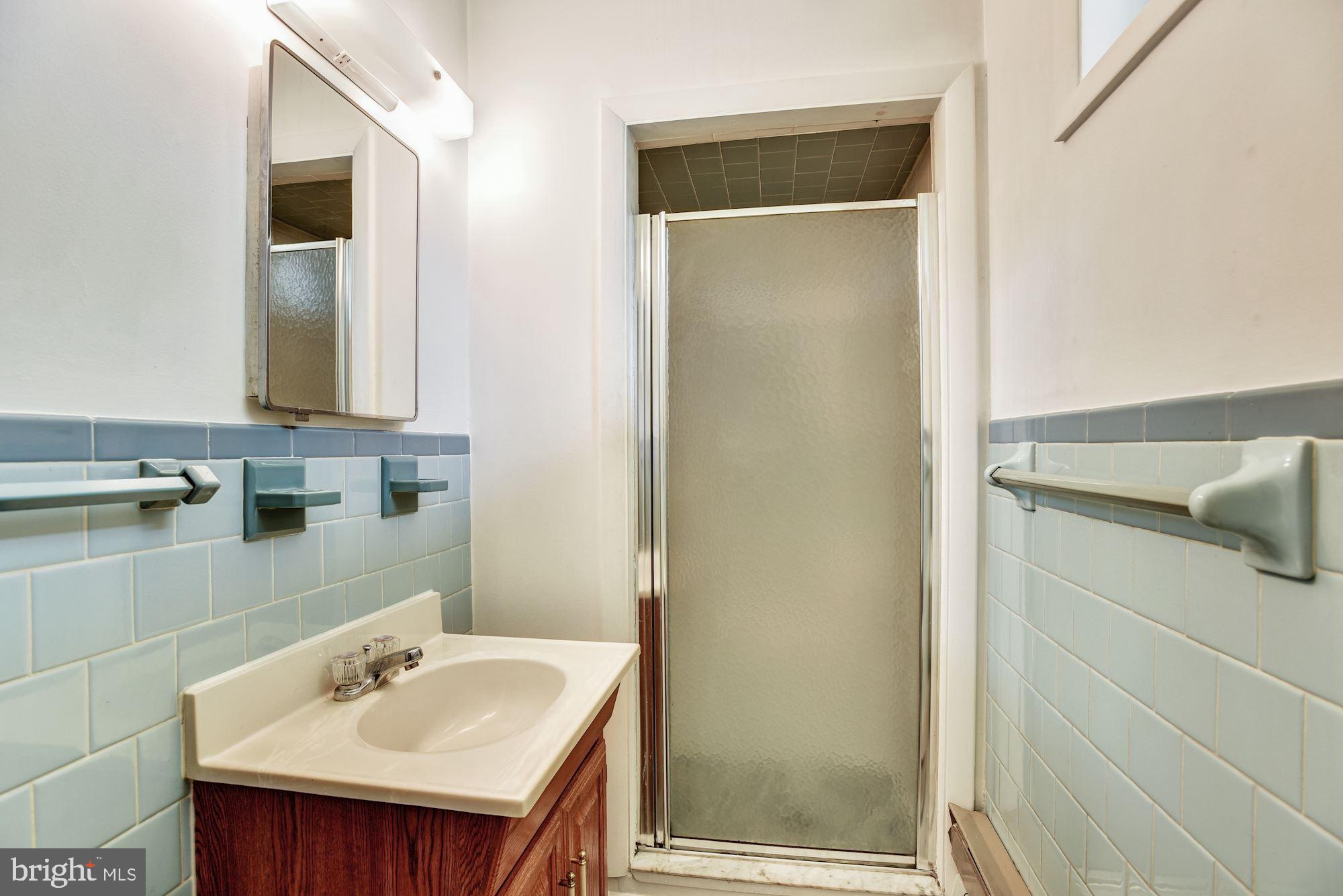 8492 Laurel Road Pasadena, MD 21122 - Photo 29 of 46 a bathroom with a sink and a mirror