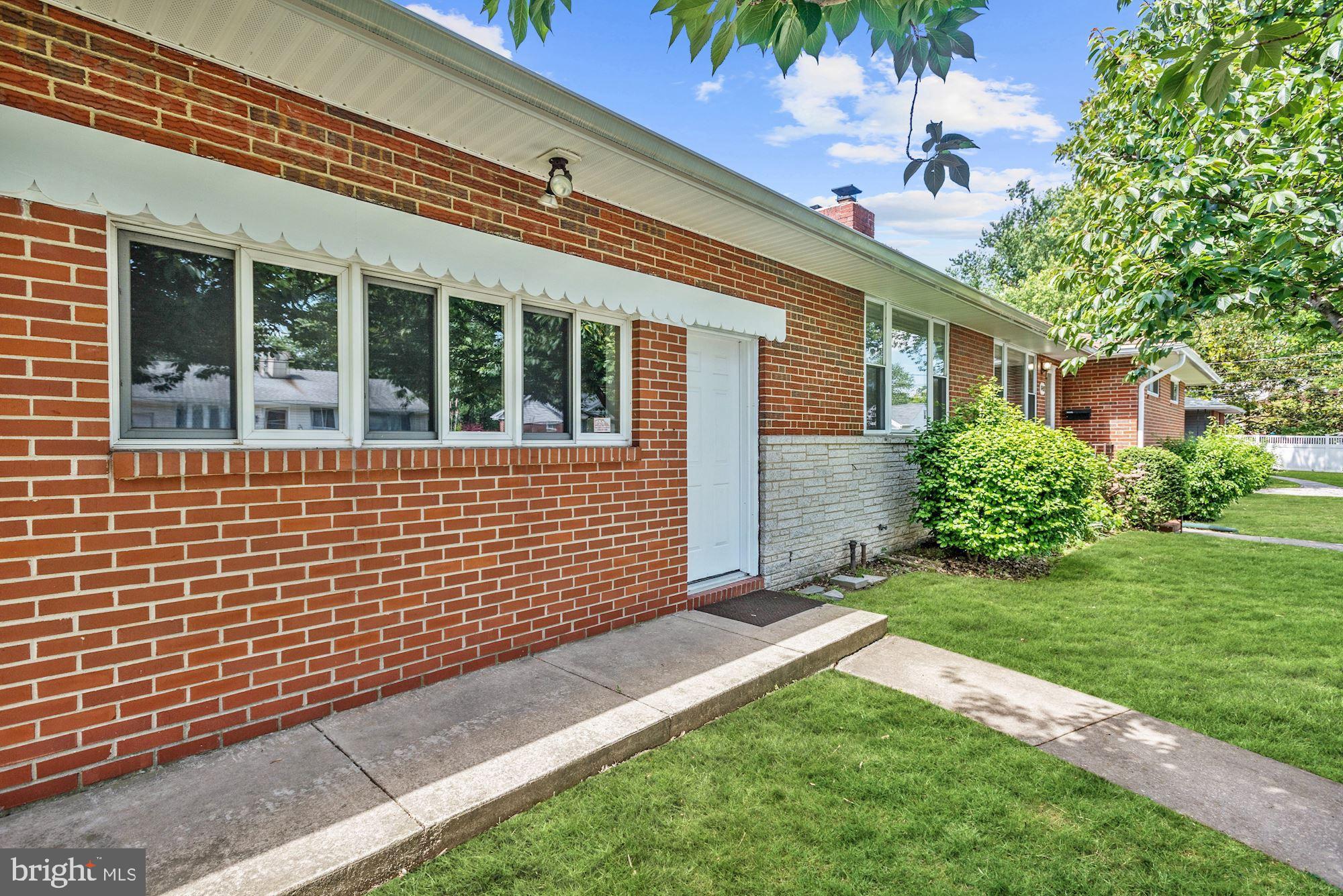 8492 Laurel Road Pasadena, MD 21122 - Photo 3 of 46 a front view of a house with a yard