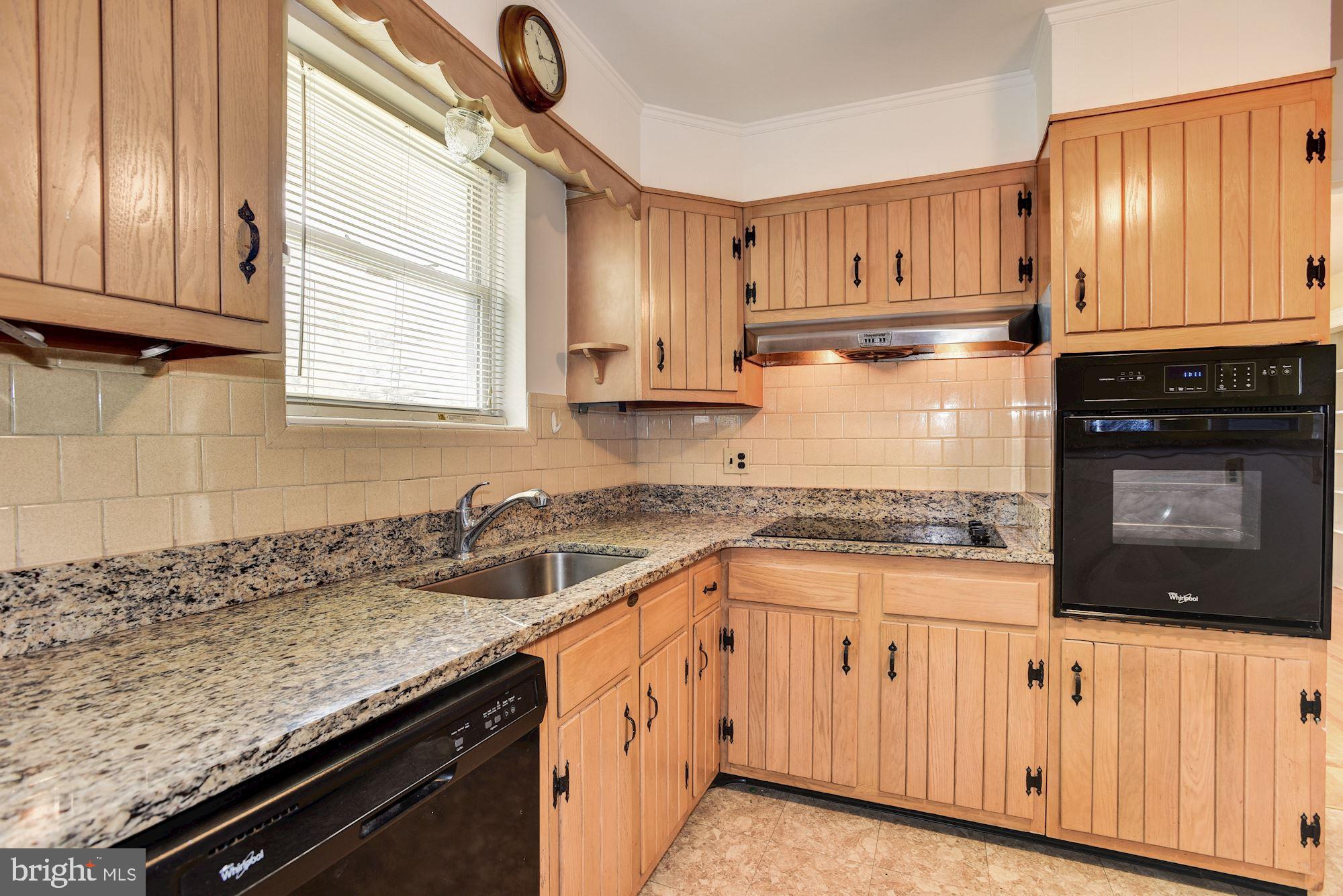 8492 Laurel Road Pasadena, MD 21122 - Photo 9 of 46 a kitchen with granite countertop a sink a stove and cabinets