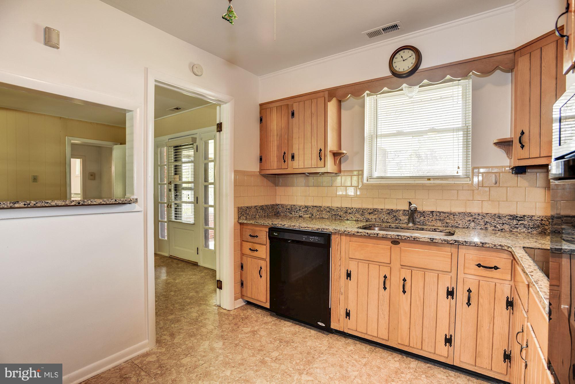 8492 Laurel Road Pasadena, MD 21122 - Photo 10 of 46 a kitchen with granite countertop a sink cabinets stainless steel appliances and a window