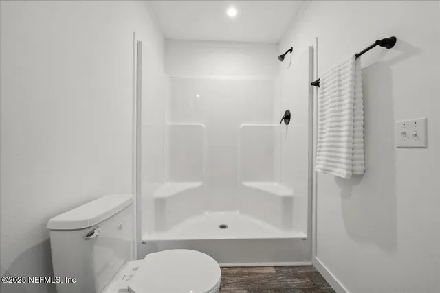 a bathroom with a shower and a toilet