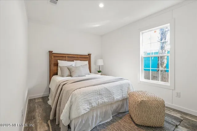 a bedroom with a bed and window