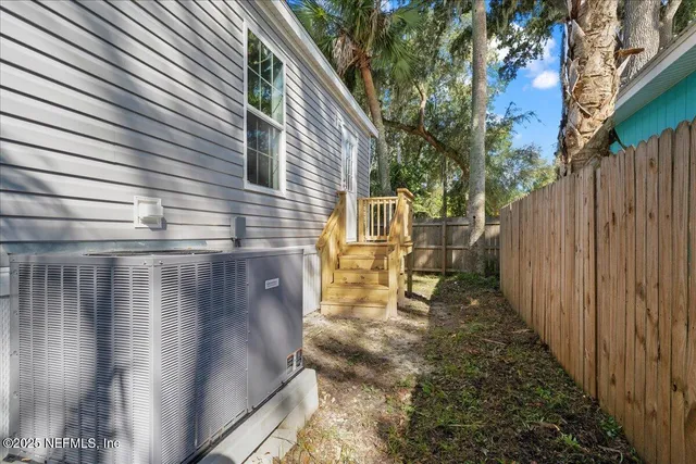 a view of a pathway of a house with wooden fence