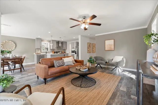 a living room with furniture and a wooden floor