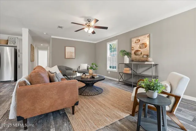 a living room with furniture and wooden floor