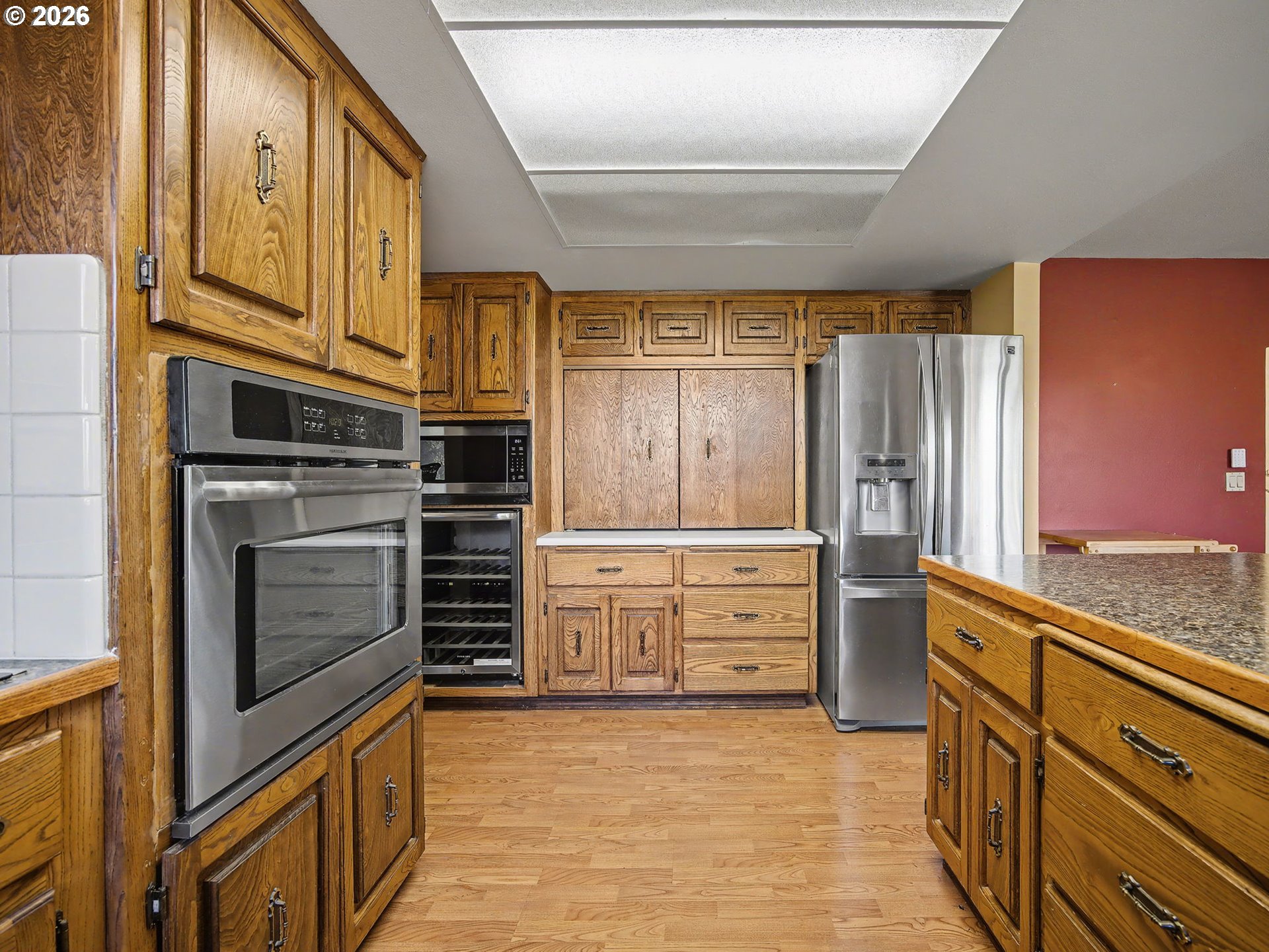 407 Southwest 7th Street Gresham, OR 97080 - Photo 12 of 48 a kitchen with stainless steel appliances cabinets and a window
