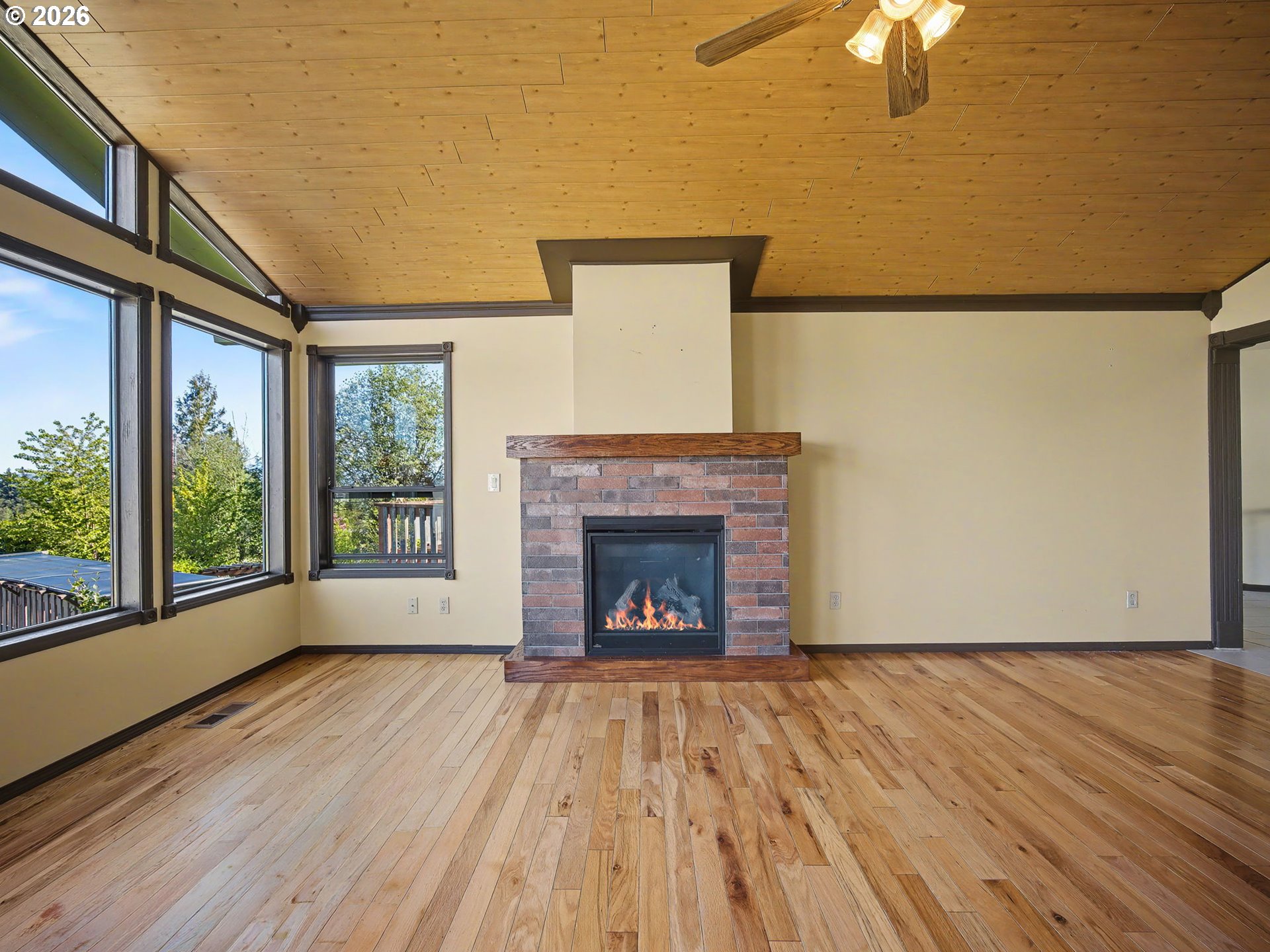 407 Southwest 7th Street Gresham, OR 97080 - Photo 4 of 48 a view of an empty room with wooden floor fireplace and a window