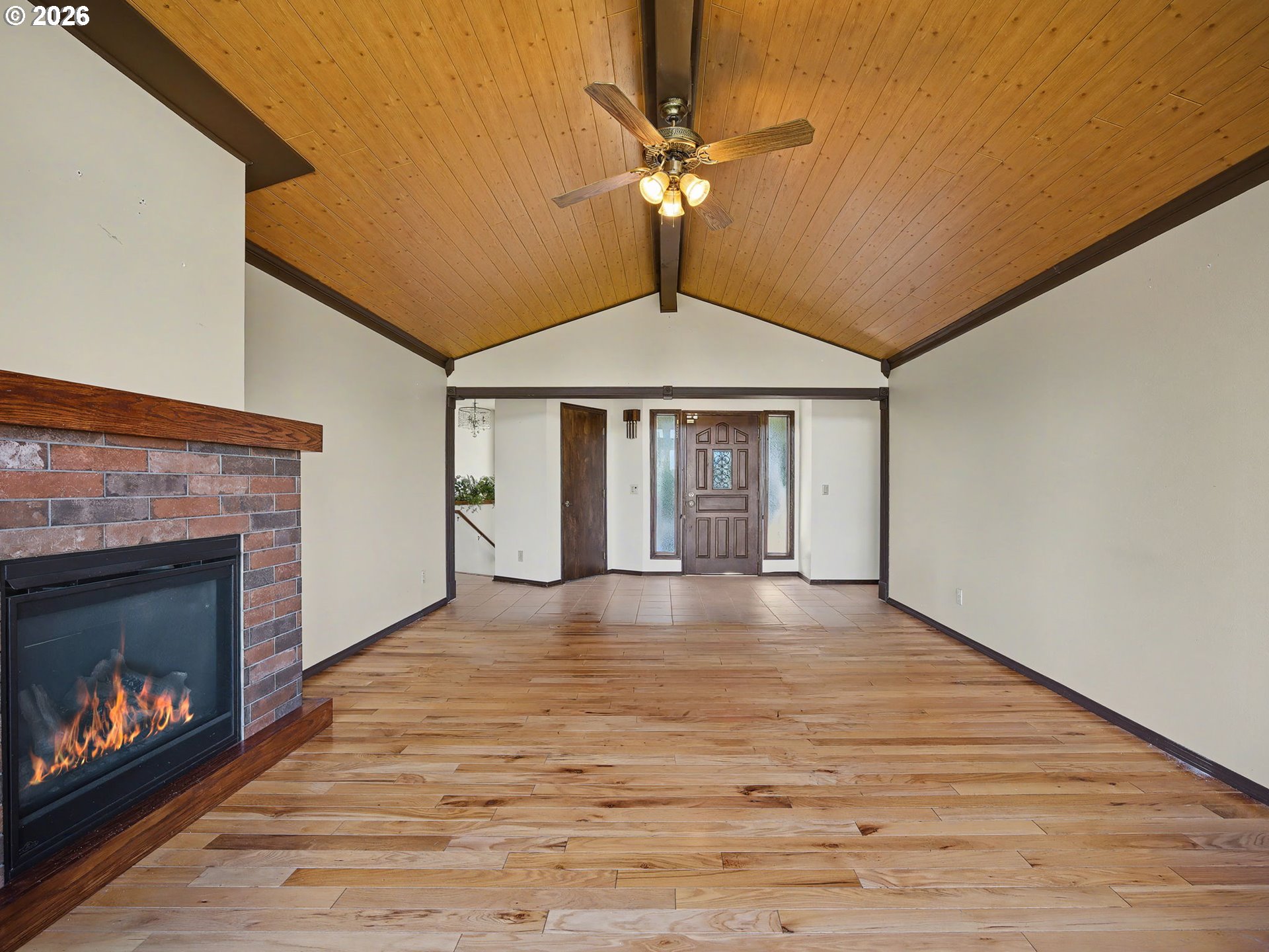 407 Southwest 7th Street Gresham, OR 97080 - Photo 6 of 48 a view of an empty room with wooden floor fireplace and a window