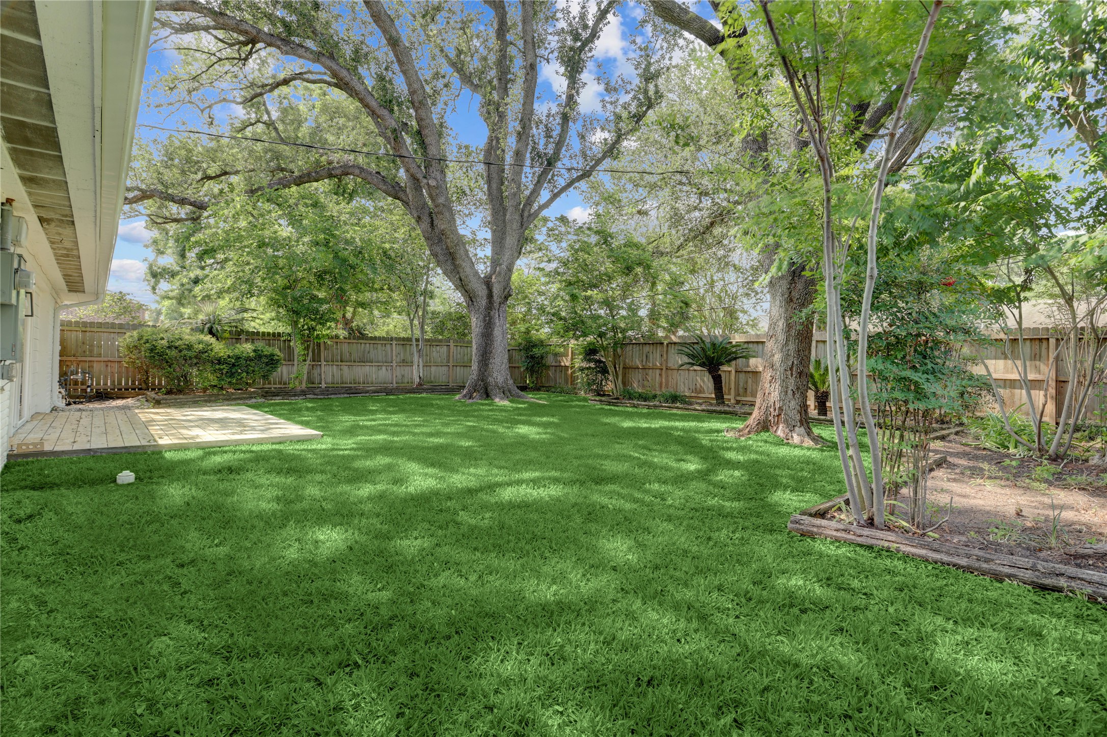 5514 Indigo Street Houston, TX 77096 - Photo 21 of 22 a view of a backyard with large trees