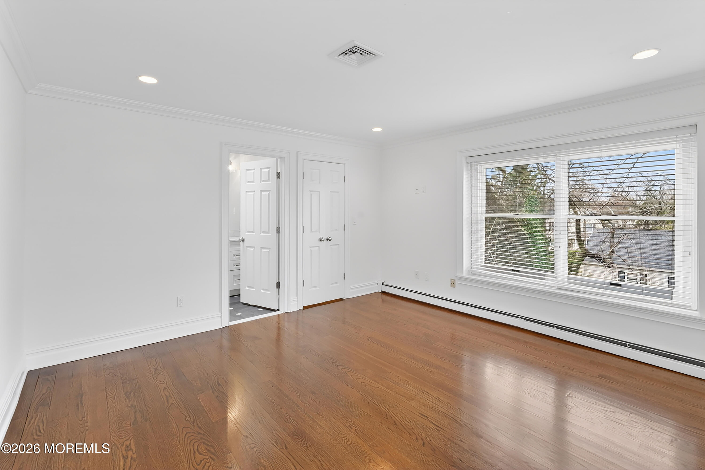 65 East River Road, Unit 20 Rumson, NJ 07760 - Photo 13 of 31 an empty room with wooden floor and windows