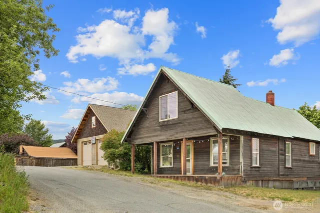 a view of a house with wooden fence
