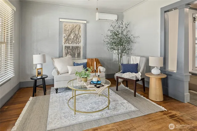a living room with furniture and a potted plant