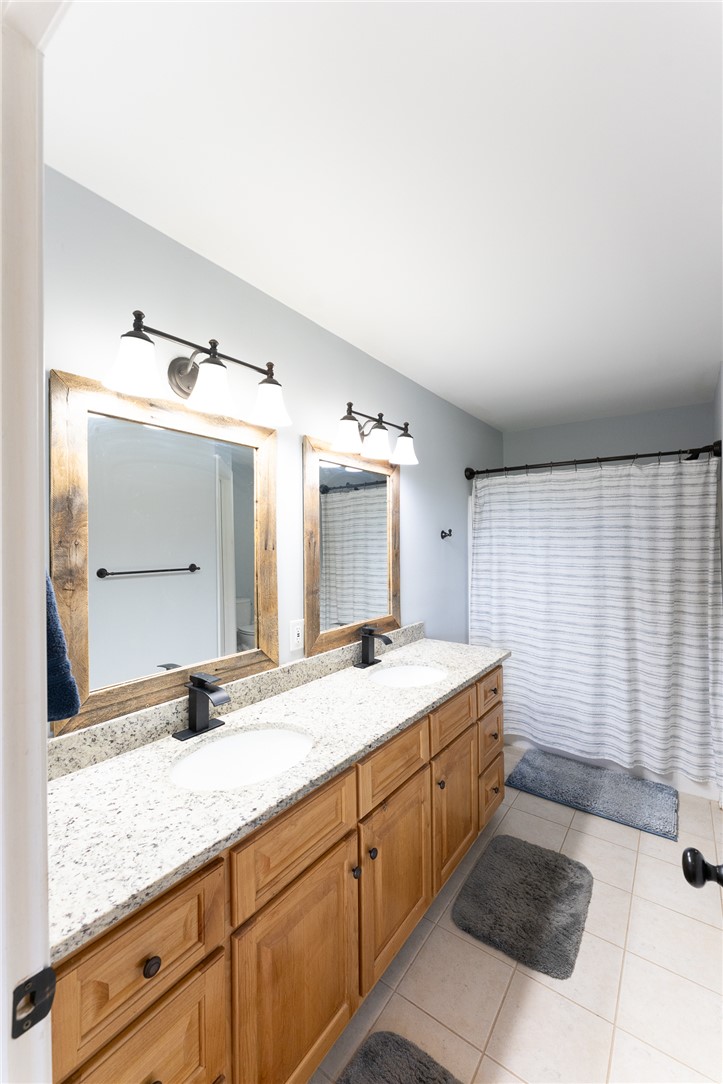 696 Mt Olivet Road Six Mile, SC 29682 - Photo 12 of 35 This bright bathroom features a spacious double vanity with ample storage and a classic shower.