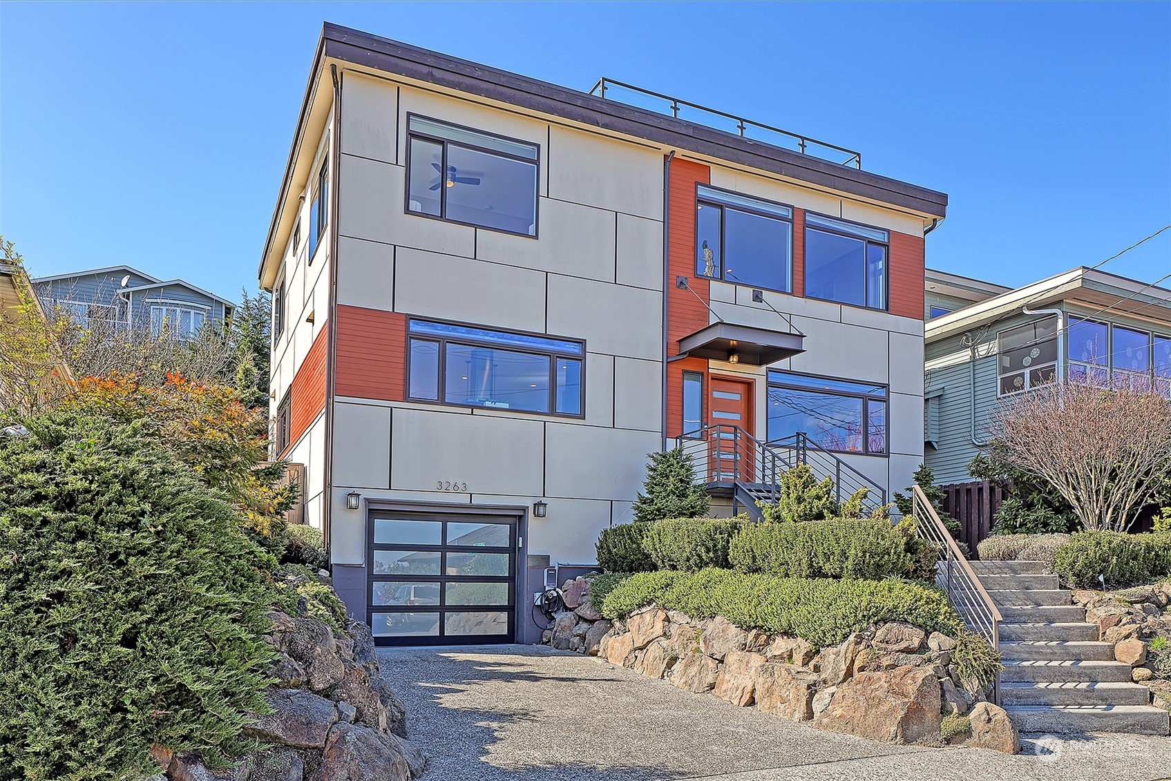3263 35th Avenue Southwest Seattle, WA 98126 - Photo 1 of 38 a front view of a house with a garden