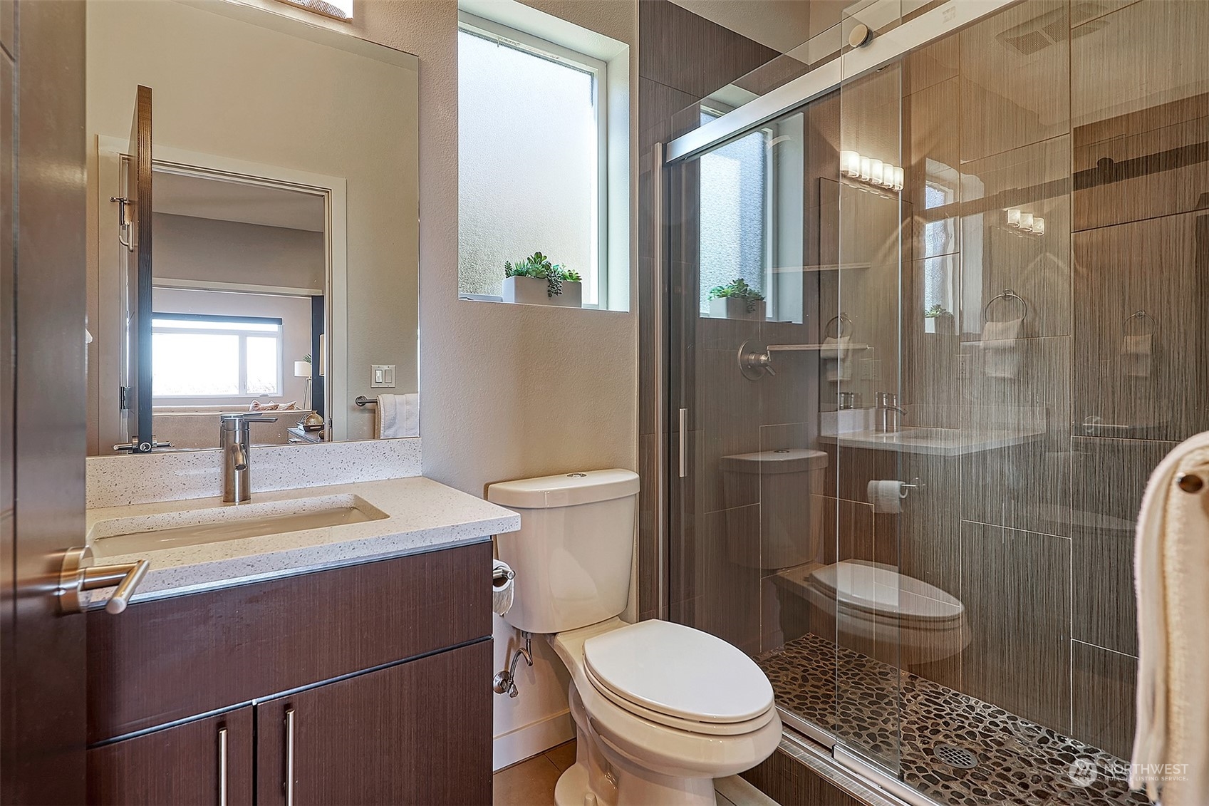 3263 35th Avenue Southwest Seattle, WA 98126 - Photo 16 of 38 a bathroom with a sink toilet a mirror and shower
