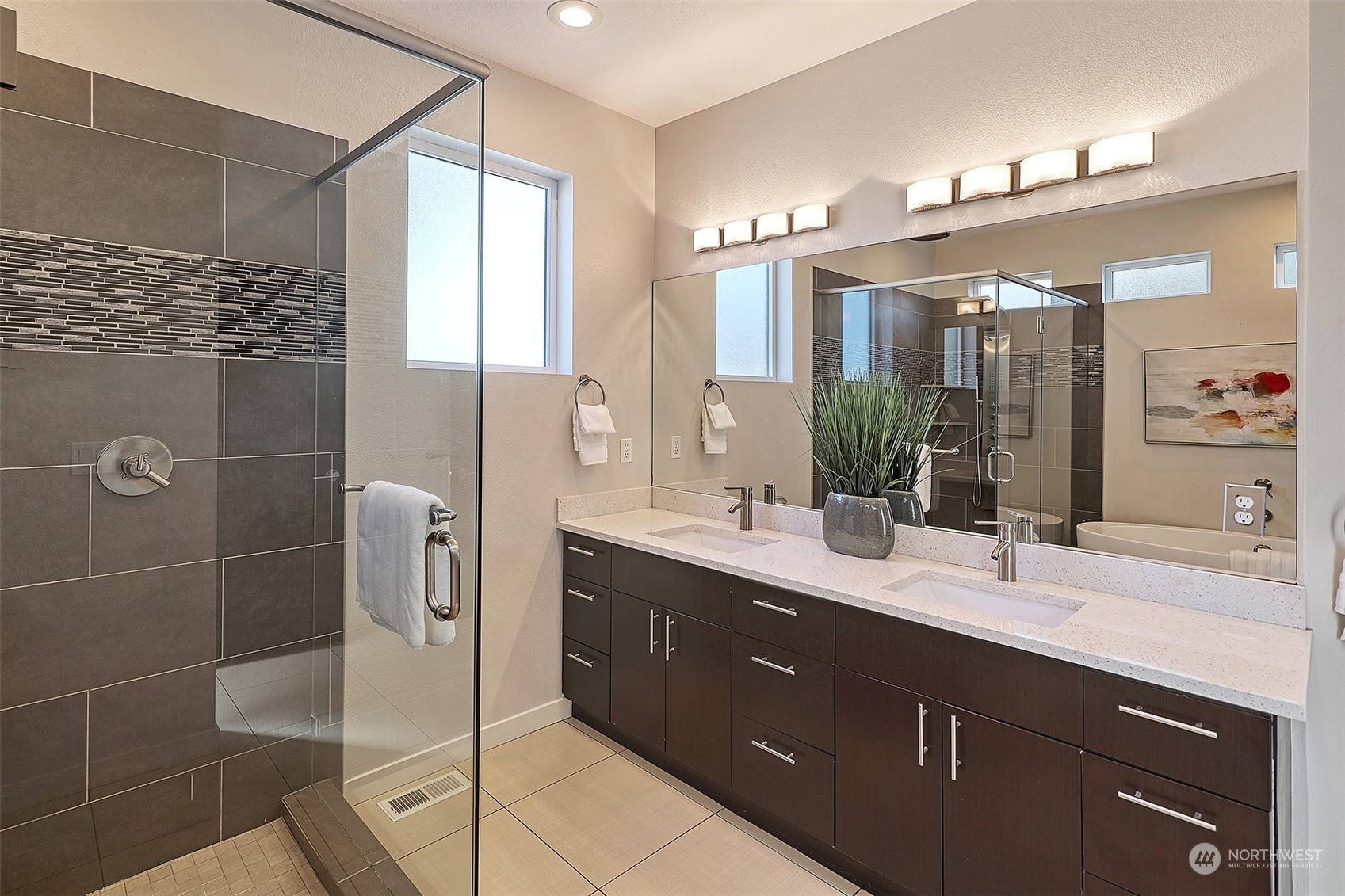 3263 35th Avenue Southwest Seattle, WA 98126 - Photo 21 of 38 a bathroom with a double vanity sink a mirror and shower