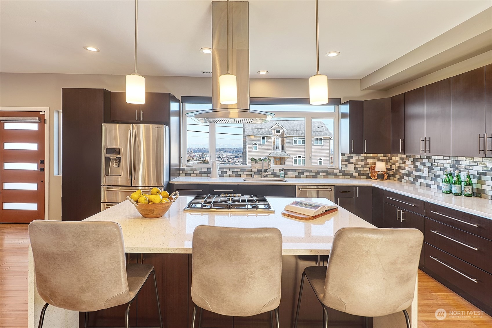 3263 35th Avenue Southwest Seattle, WA 98126 - Photo 6 of 38 a kitchen with stainless steel appliances a dining table chairs and a refrigerator