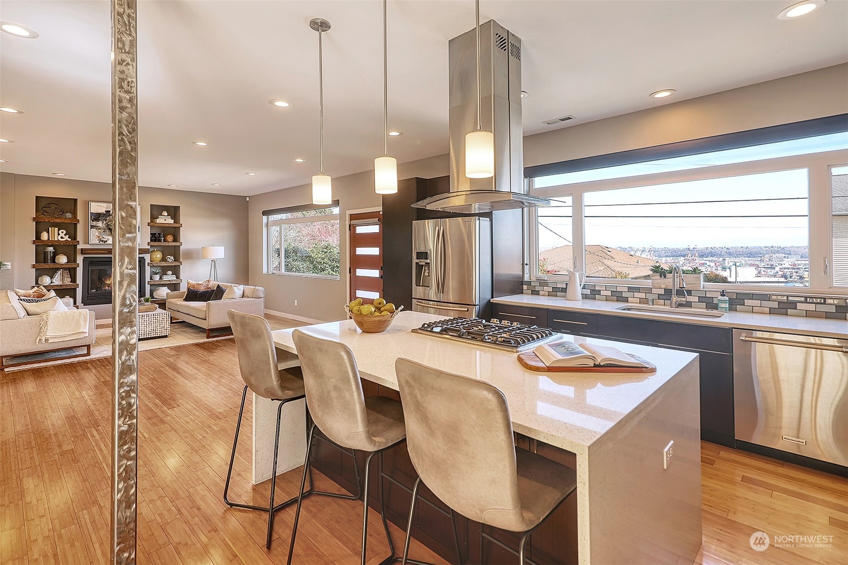 3263 35th Avenue Southwest Seattle, WA 98126 - Photo 7 of 38 a room with stainless steel appliances kitchen island granite countertop a table chairs and a view of living room