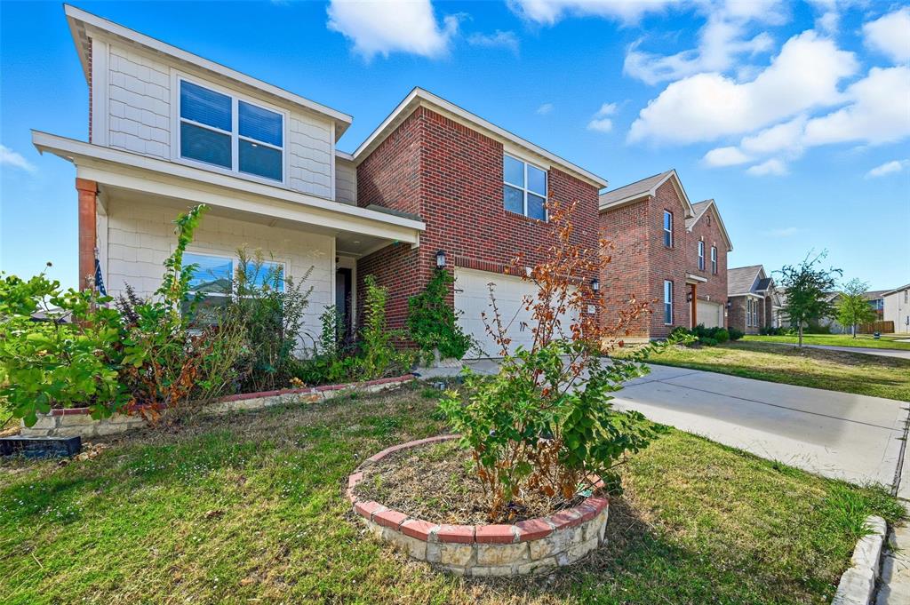 7612 Duck Bay Road Fort Worth, TX 76120 - Photo 3 of 32 a front view of a house with garden