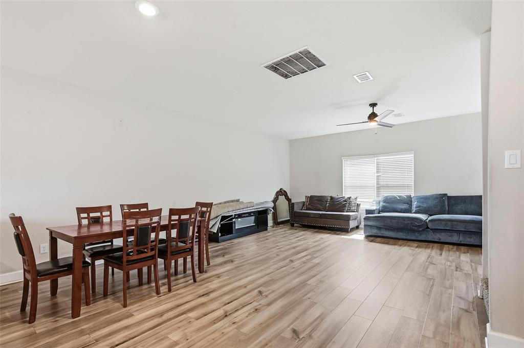 7612 Duck Bay Road Fort Worth, TX 76120 - Photo 6 of 32 a living room with furniture and wooden floor