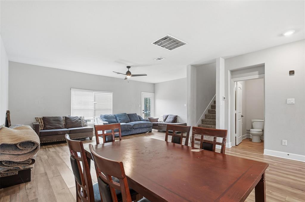 7612 Duck Bay Road Fort Worth, TX 76120 - Photo 7 of 32 a view of a dining room with furniture window and wooden floor