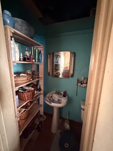 a bathroom with a toilet sink and mirror