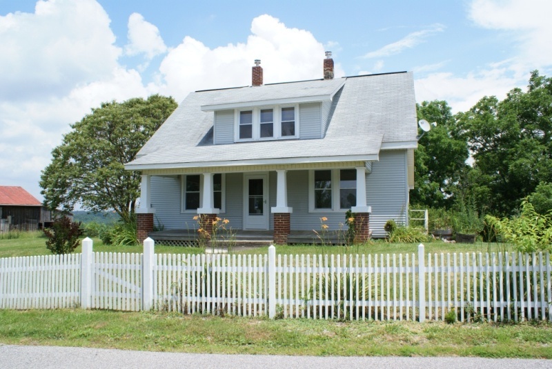 921 White Oak Grove Road Northeast Riner, VA 24149 - Photo 1 of 1 a front view of a house with a garden and plants
