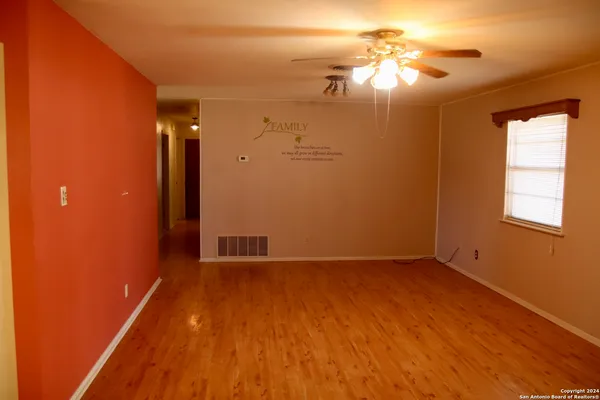 wooden floor in an empty room with a window