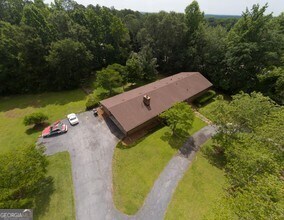 an aerial view of a house with garden space and street view