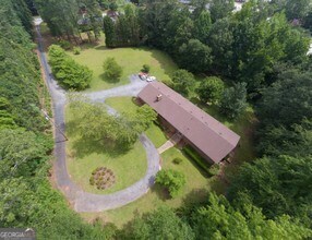 6190 Prestley Mill Road Douglasville, GA 30134 - Photo 3 of 12 an aerial view of a house with a yard and trees