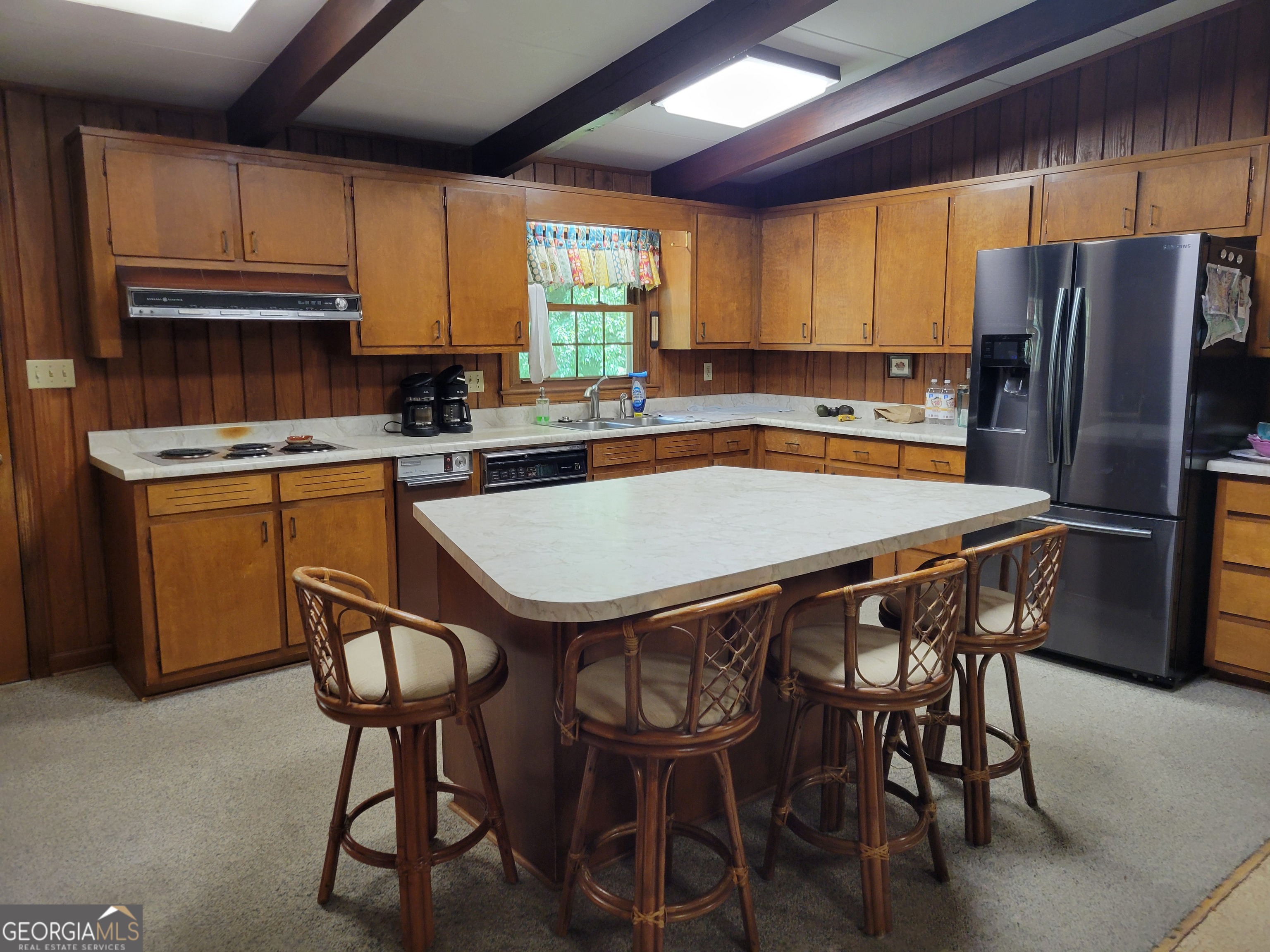 6190 Prestley Mill Road Douglasville, GA 30134 - Photo 5 of 12 a kitchen with stainless steel appliances a table chairs refrigerator and microwave