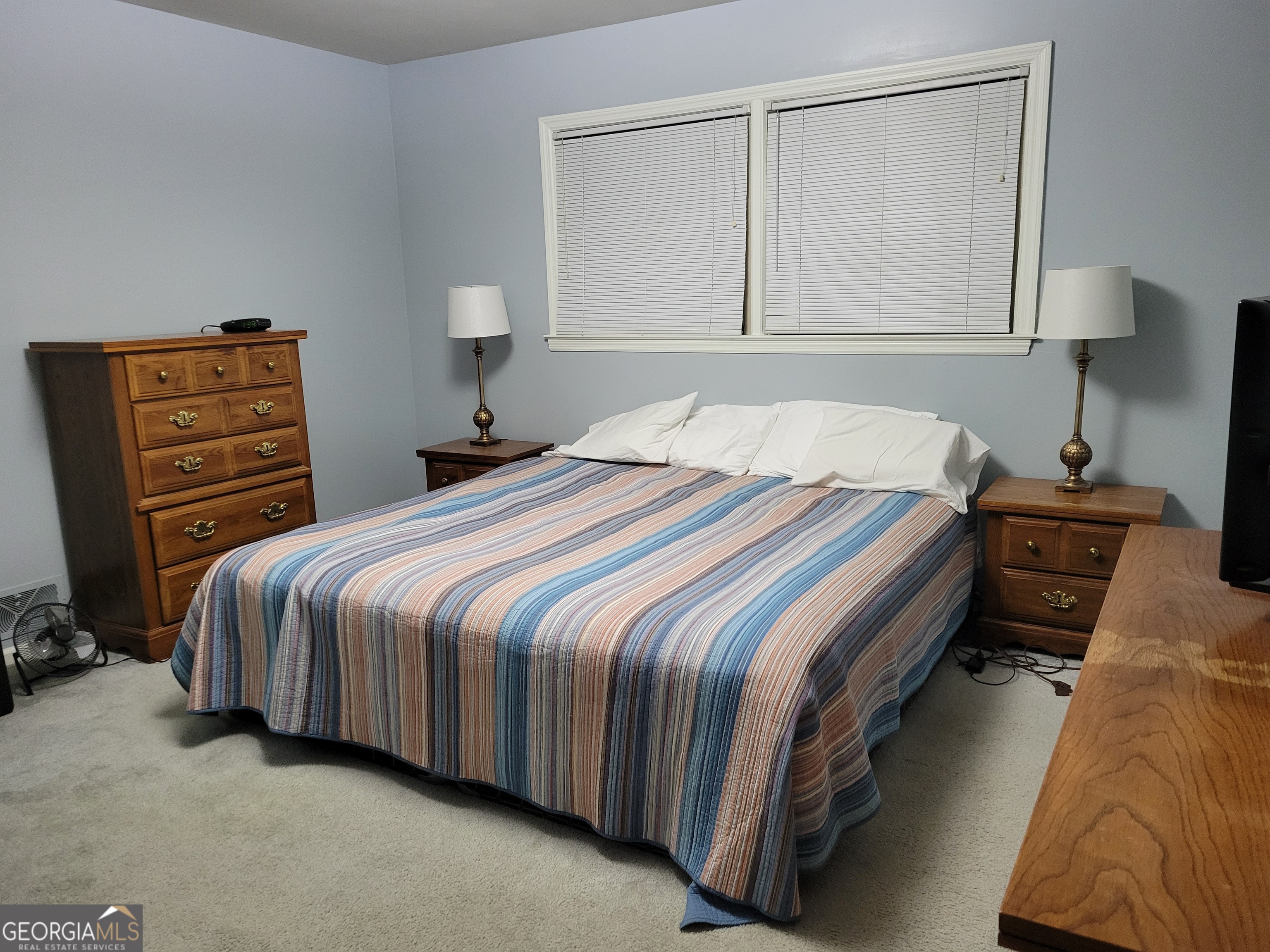 6190 Prestley Mill Road Douglasville, GA 30134 - Photo 10 of 12 a bedroom with a bed and a lamp on dresser