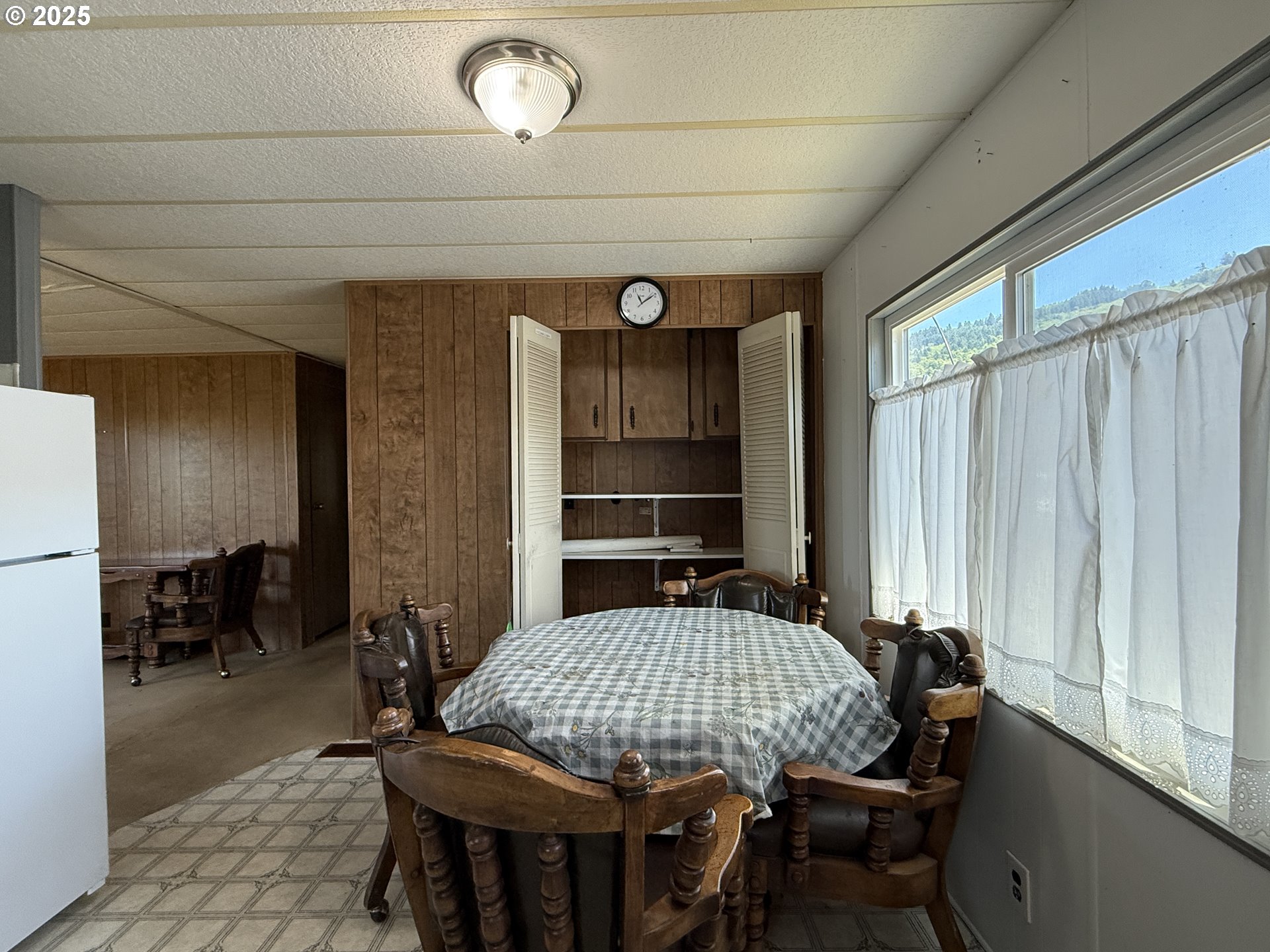 98620 Camellia Drive Brookings, OR 97415 - Photo 11 of 26 a view of a dining room with furniture window and wooden floor