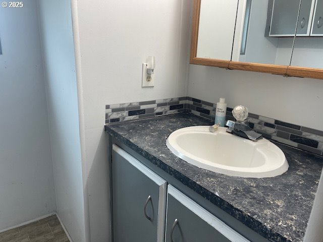 98620 Camellia Drive Brookings, OR 97415 - Photo 16 of 26 a bathroom with a granite countertop sink and a mirror