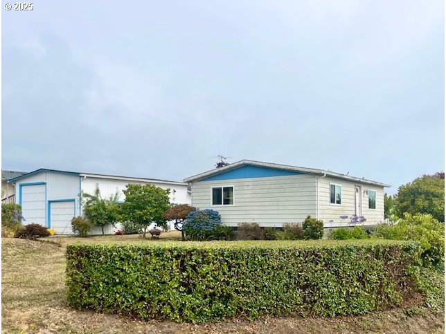 98620 Camellia Drive Brookings, OR 97415 - Photo 2 of 26 front view of a house with a yard