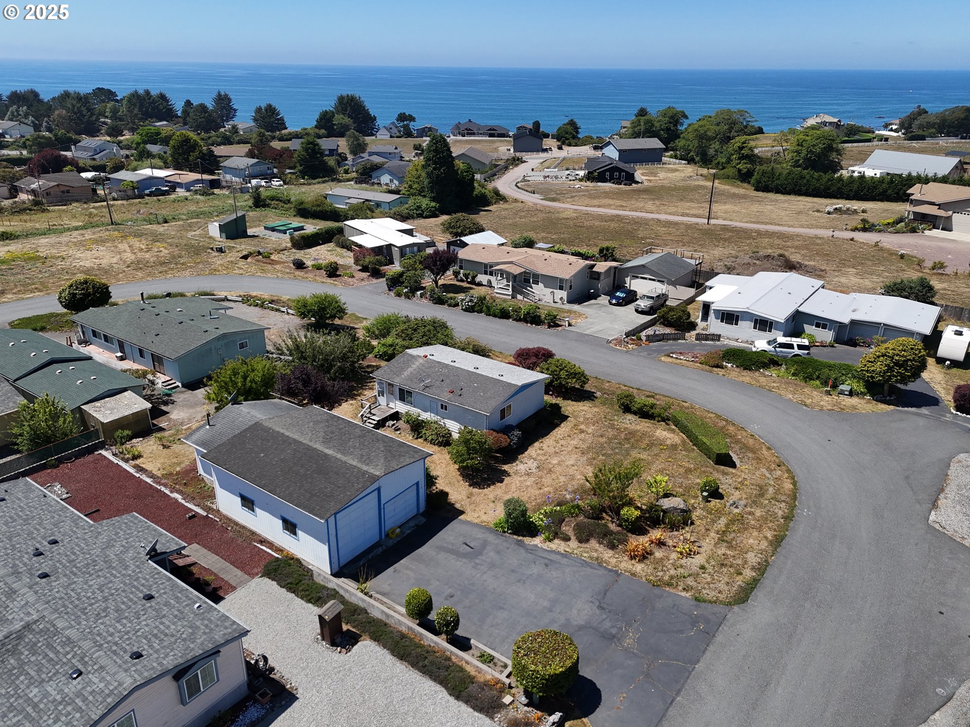 98620 Camellia Drive Brookings, OR 97415 - Photo 3 of 26 an aerial view of a houses and city view