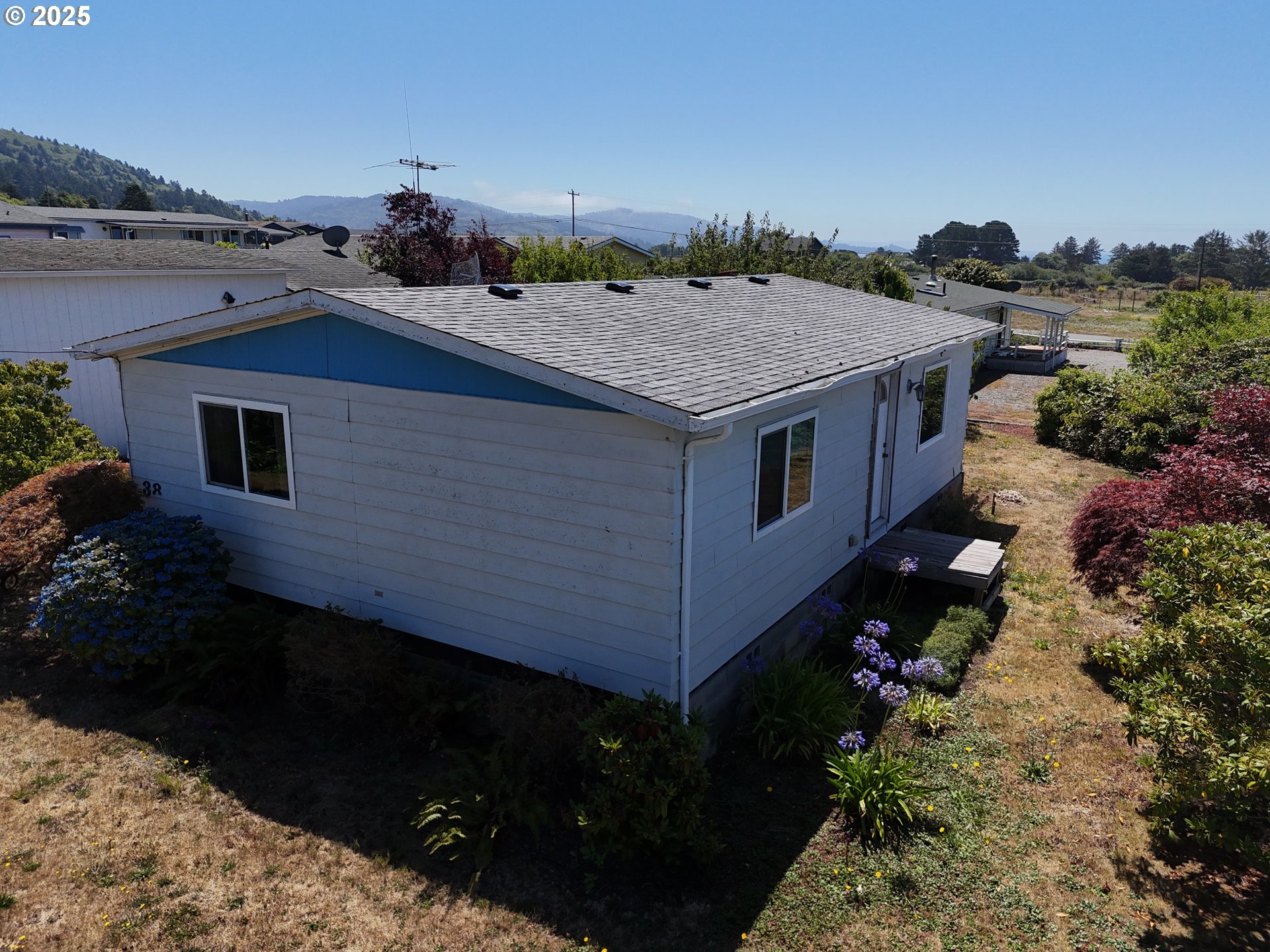 98620 Camellia Drive Brookings, OR 97415 - Photo 4 of 26 a aerial view of a house with a yard