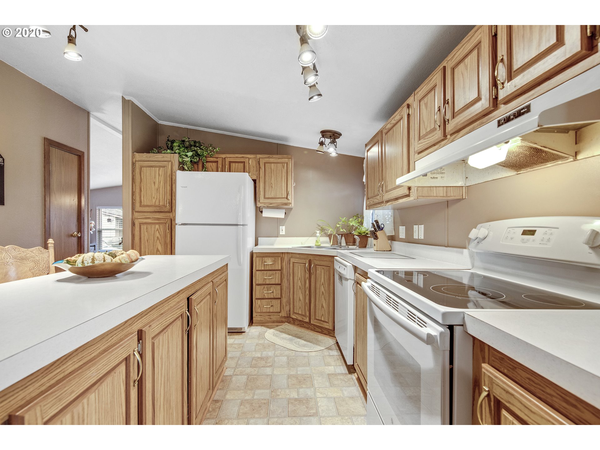 1500 South Sandoz Road, Unit 33 Newberg, OR 97132 - Photo 8 of 29 a kitchen with a sink a stove a refrigerator and cabinets