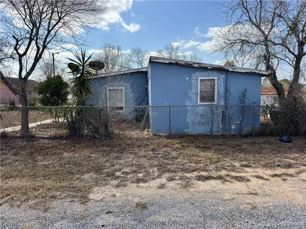 a small barn with a oven on the side of it