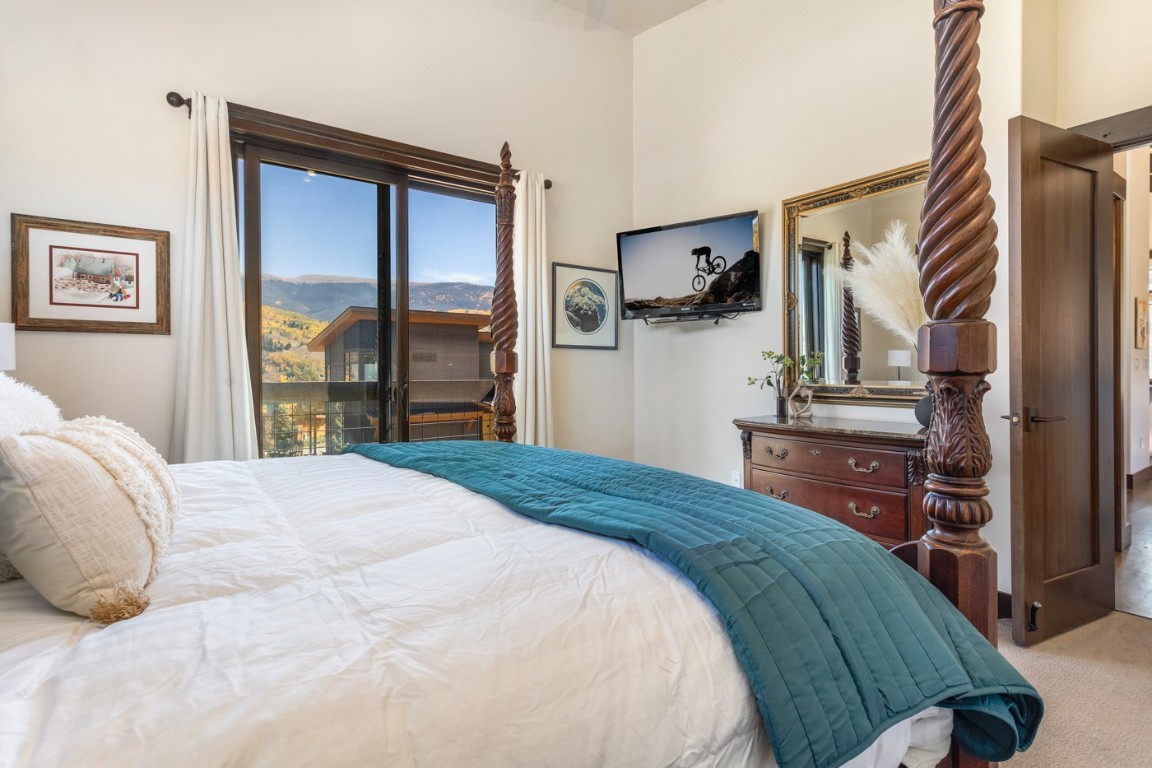 151 Moss Way Silverthorne, CO 80498 - Photo 14 of 31 a bedroom with a bed and wooden floor