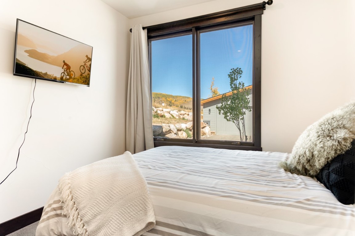 151 Moss Way Silverthorne, CO 80498 - Photo 16 of 31 a bedroom with a large bed and a window