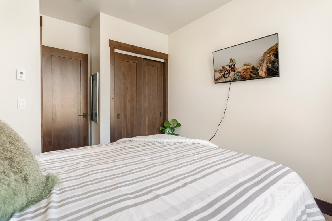 151 Moss Way Silverthorne, CO 80498 - Photo 17 of 31 a bedroom with a bed and wall painting