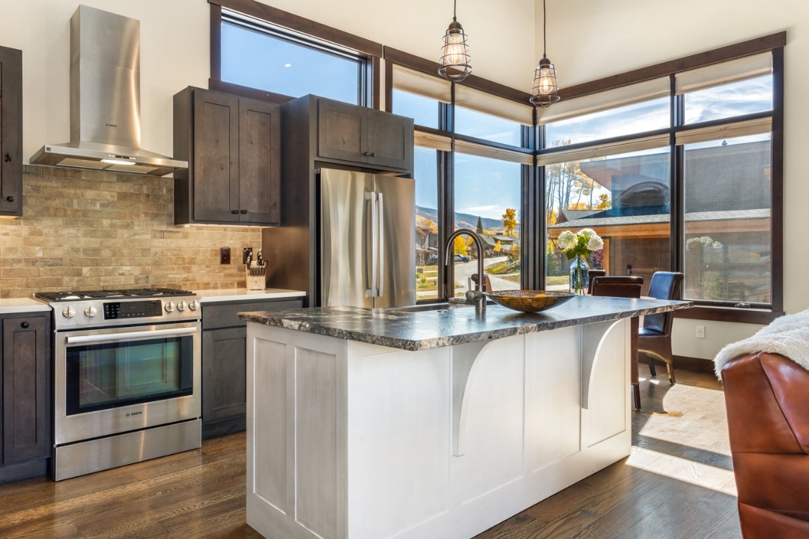 151 Moss Way Silverthorne, CO 80498 - Photo 6 of 31 a kitchen with stainless steel appliances granite countertop a refrigerator a stove and a sink with wooden floor
