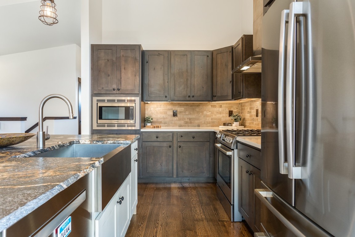 151 Moss Way Silverthorne, CO 80498 - Photo 7 of 31 a kitchen with stainless steel appliances granite countertop a sink stove and refrigerator