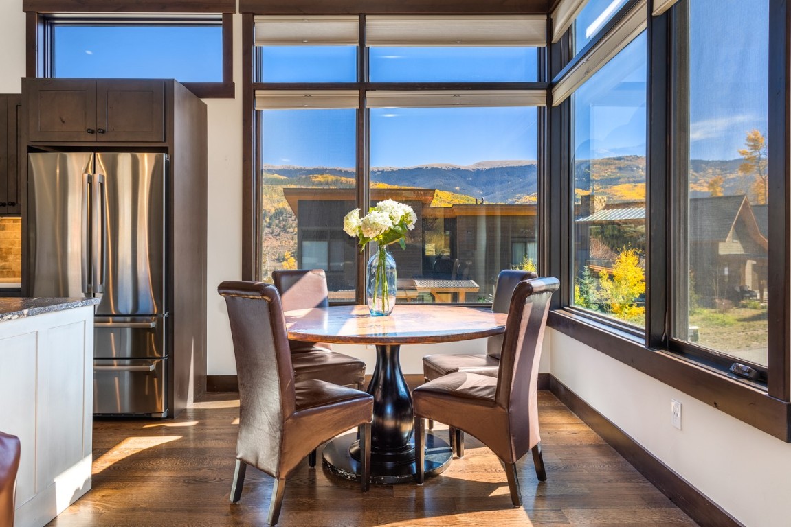 151 Moss Way Silverthorne, CO 80498 - Photo 9 of 31 a dining room with furniture a chandelier and wooden floor