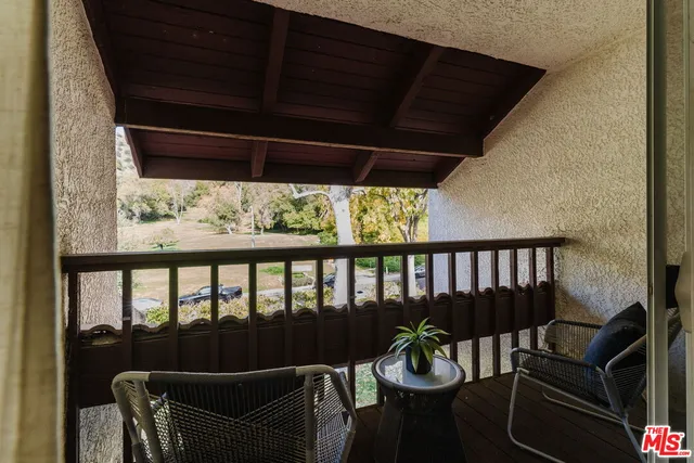 a view of a chair and table in the balcony